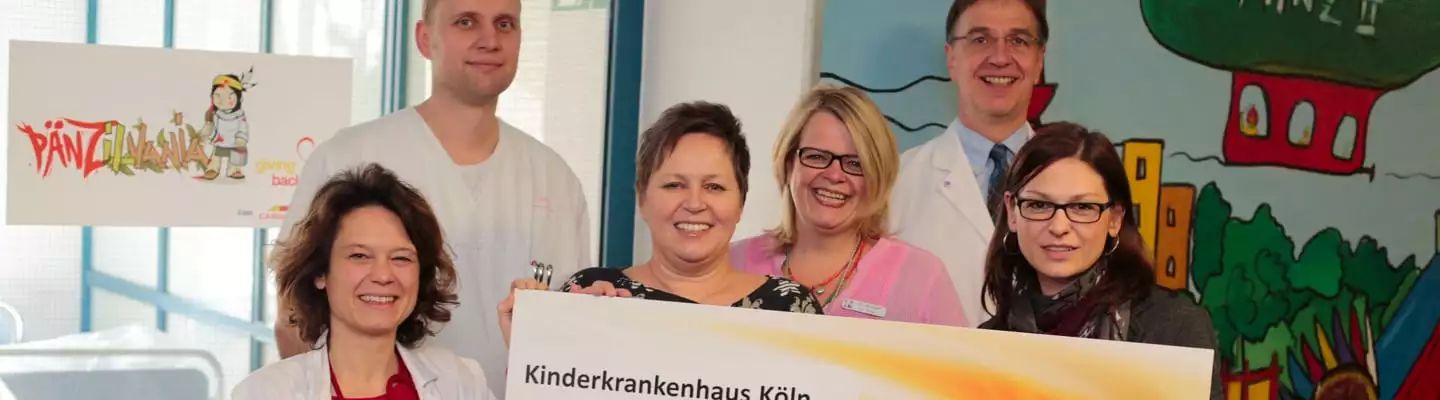 en.6 Menschen die eine Spende an ein Kinderkrankenhaus übergeben